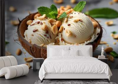 Coconut bowl filled with creamy coconut ice cream topped with crunchy peanuts and fresh mint leaves Wall mural