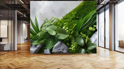 Decorative gravel and concrete background with lush green grass and textured plant leaves, creating a harmonious blend of nature and modern design Wall mural