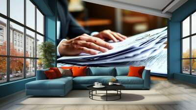 Efficient organization of paperwork by a business professionals hands at a tidy desk Wall mural