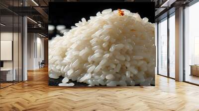 Elegant pile of uncooked white rice on a sleek black background Wall mural