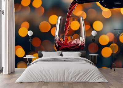 Elegant red wine pouring into a glass with a soft bokeh light backdrop Wall mural