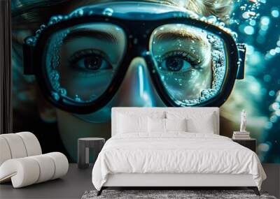 Enigmatic underwater portrait with diving goggles revealing intricate light patterns and bubbles around an immersed face Wall mural