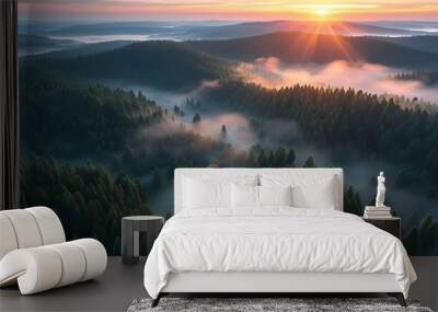 ethereal sunrise illuminating mist-covered conifer forest from above Wall mural