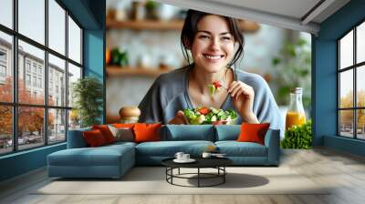 Joyful Caucasian woman enjoying a fresh salad, embracing healthy eating and wellness habits Wall mural