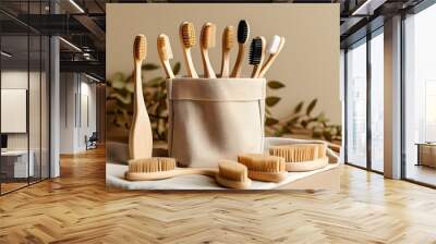 Minimalistic display of natural wooden toothbrushes in a cloth bag on a warm beige backdrop, symbolizing sustainable living choices Wall mural