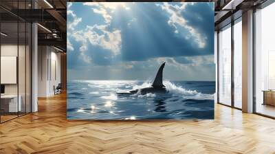 Mysterious shark fin emerging from serene ocean surface beneath a cloudy blue sky, blending tranquility with an underlying sense of danger Wall mural