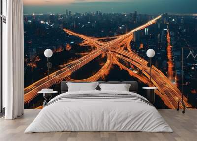 Nighttime aerial panorama of intersecting urban expressways illuminated by city lights Wall mural