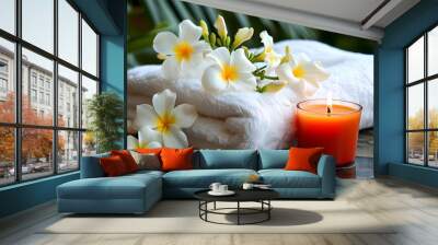 Relaxing spa ambiance with white towels, glowing candles, and fragrant frangipani flowers Wall mural