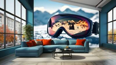 Ski goggles resting on snowy surface, reflecting majestic mountain peak in bright sunlight Wall mural