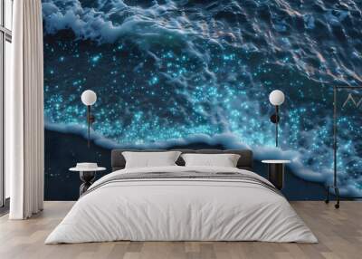 Stunning aerial view of bioluminescent waves illuminating a tropical beach, showcasing the mesmerizing glow of plankton and vibrant fluorescent particles Wall mural