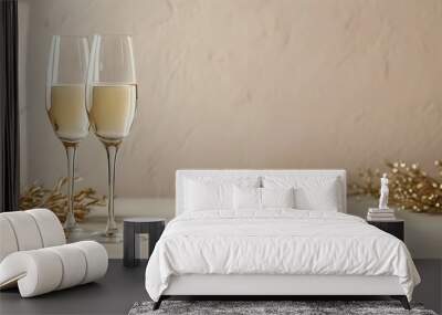 Stylish glass champagne glasses on a soft beige backdrop with ample empty copy space for text or design elements Wall mural