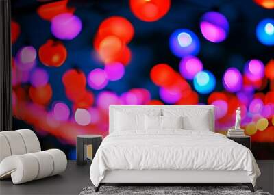 Vibrant display of colorful bokeh lights sparkling in reds, purples, and blues at a festive evening event Wall mural