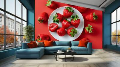 Vibrant strawberries on a white plate against a bold red background, a fresh and inviting flat lay with ample copy space Wall mural