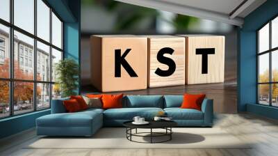 Wooden blocks forming the letters KST, symbolizing creativity and business innovation Wall mural