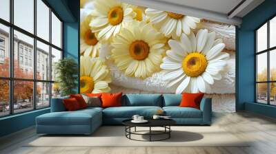 Yellow daisy close-up on a white spa towel, symbolizing beauty and relaxation in a serene treatment setting Wall mural