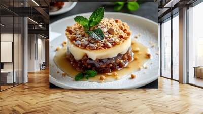 Decadent layered dessert with crunchy topping and fresh mint garnish on a pristine white plate Wall mural