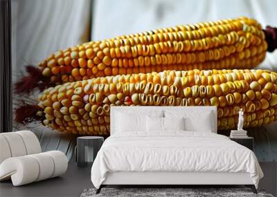 Fresh ears of corn in husks displayed on rustic whitewashed wood Wall mural