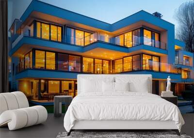 Illuminated modern home featuring numerous windows and a stylish balcony Wall mural