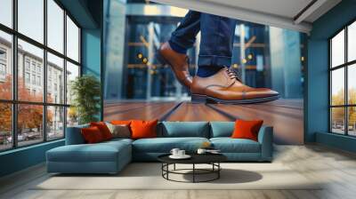 A close-up of the feet and shoes of an elegant man in business attire walking on concrete Wall mural