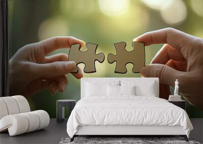 A pair of hands put two pieces of the puzzle together Wall mural