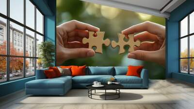 A pair of hands put two pieces of the puzzle together Wall mural