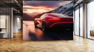 A red sports car is driving on the road, with mountains in front of it and a sunset behind it Wall mural