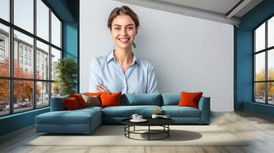 Happy young smiling confident professional business woman wearing blue shirt, pretty stylish female executive looking at camera, standing arms crossed isolated at gray background, Generative AI Wall mural