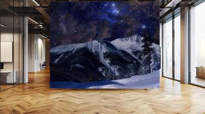 Snow-covered mountain landscape under a starry night sky with the Milky Way visible. Serene and majestic winter scenery with bright stars and clear Wall mural