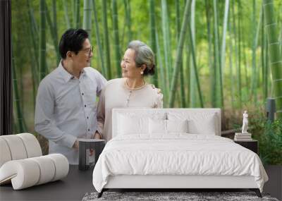 An Asian elderly couple walking in the bamboo forest Wall mural