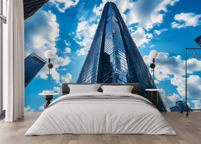 A modern skyscraper stands under the blue sky and white clouds, showing the city's prosperity and sense of technology. Wall mural