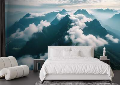 Stunning aerial view of mountains with cloudy sky, overlooking natural beauty. Wall mural