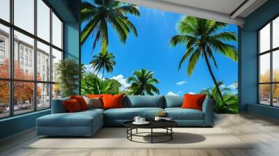 Tropical vegetation under the blue sky, the sun shines on the green palm trees, showing a tranquil natural landscape. Wall mural