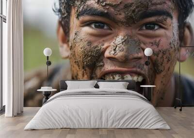 A close-up shot of a rugby player’s face as they celebrate a try, with sweat and mud on their brow  Wall mural