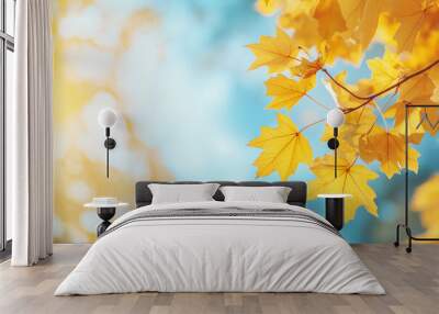 Autumn background with blurred autumn leaves and sun rays on a blue sky Wall mural