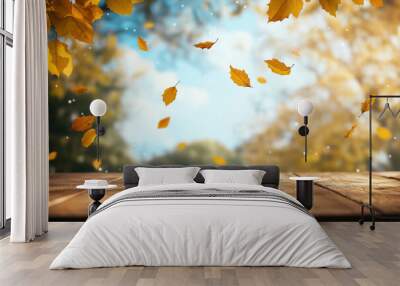 Wooden table with an autumn background and blurred golden-yellow bokeh light, with falling leaves in the air Wall mural