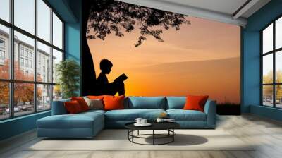 Silhouettes of children reading expectations on a tree Wall mural